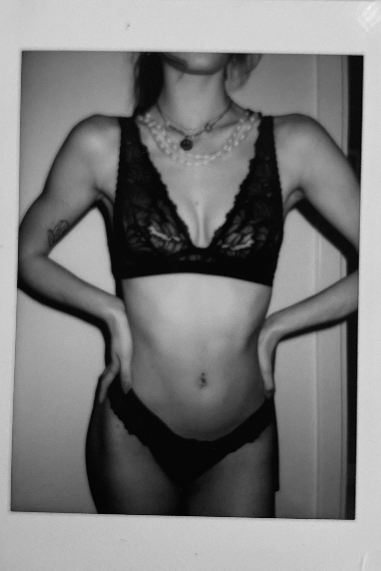 Black and white polaroid picture of a women wearing the roxy bralette